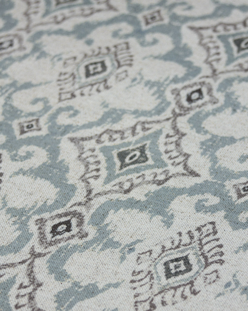 Geometric Ikat inspired design in blue and brown on a polycotton and linen curtain fabric