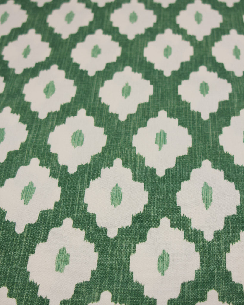 Green cotton curtain fabric with white geometric ikat design