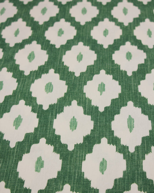 Green cotton curtain fabric with white geometric ikat design