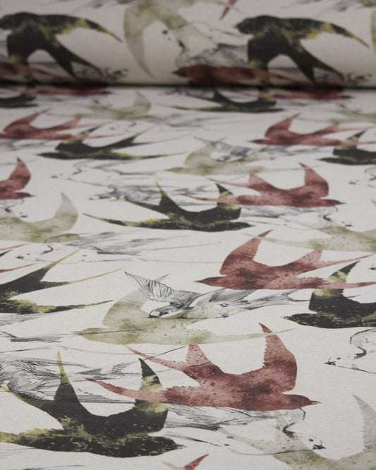 Curtain fabric with swallows in earthy browns and reds on a neutral polycotton base