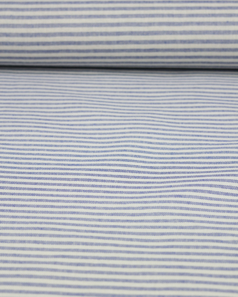 Roll of fabric with blue and white striped pattern