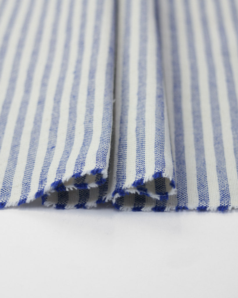 Close-up of blue and white striped fabric on a white background
