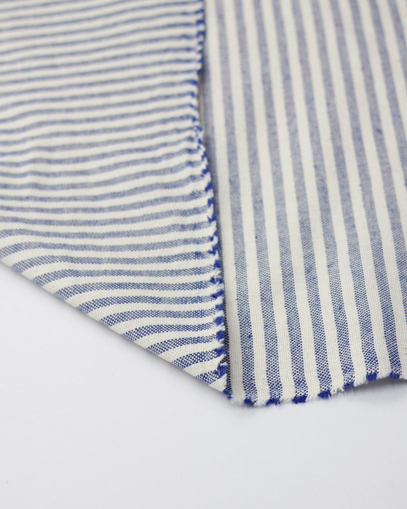 Close-up of blue and white striped fabric on a white background
