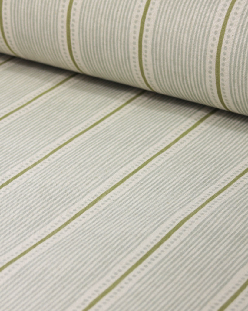 Roll of curtain fabric with green stripes on a white background