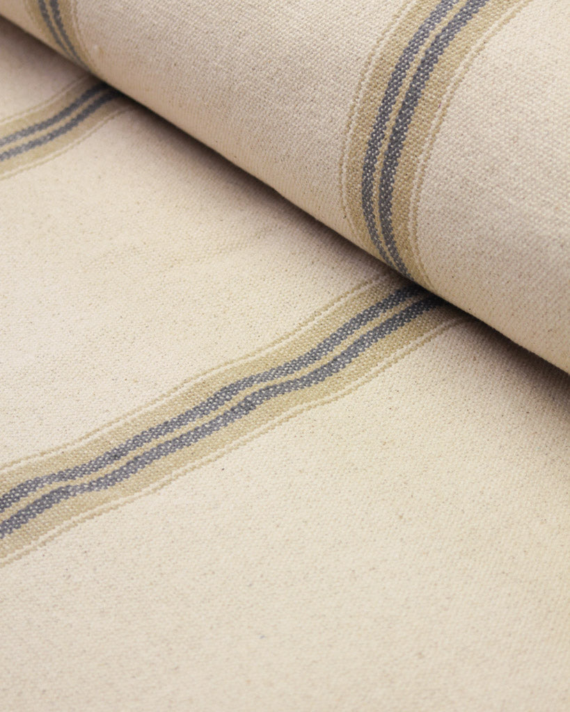 Striped heavy woven cotton curtain or interiors fabric featuring a warm beige base with two vertical stripes in slate grey and tan