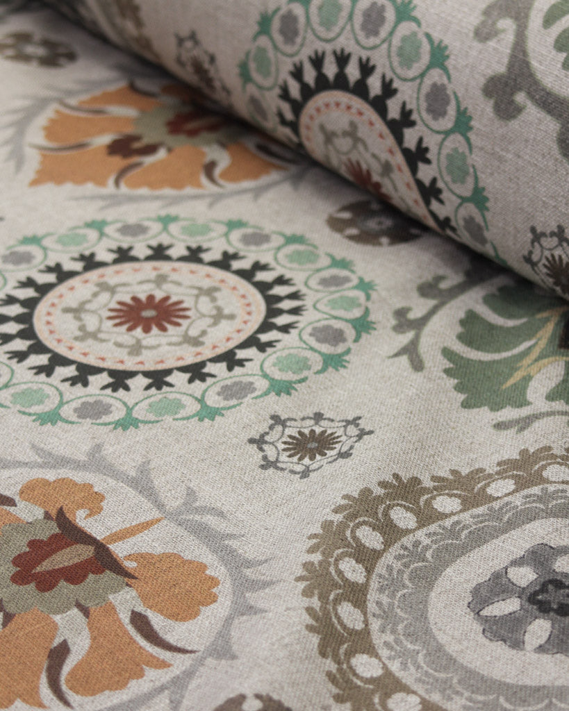 Close-up of patterned curtain fabric with circular designs in various colours.