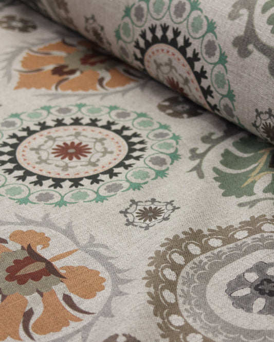 Close-up of patterned curtain fabric with circular designs in various colours.