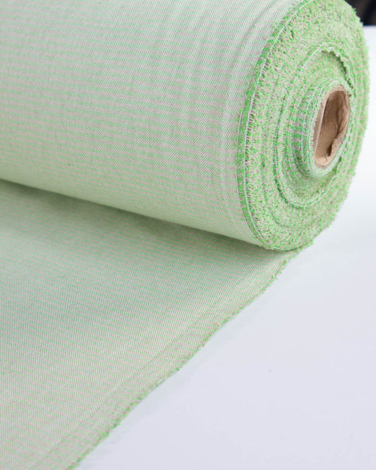 A roll of green and beige upholstery fabric 