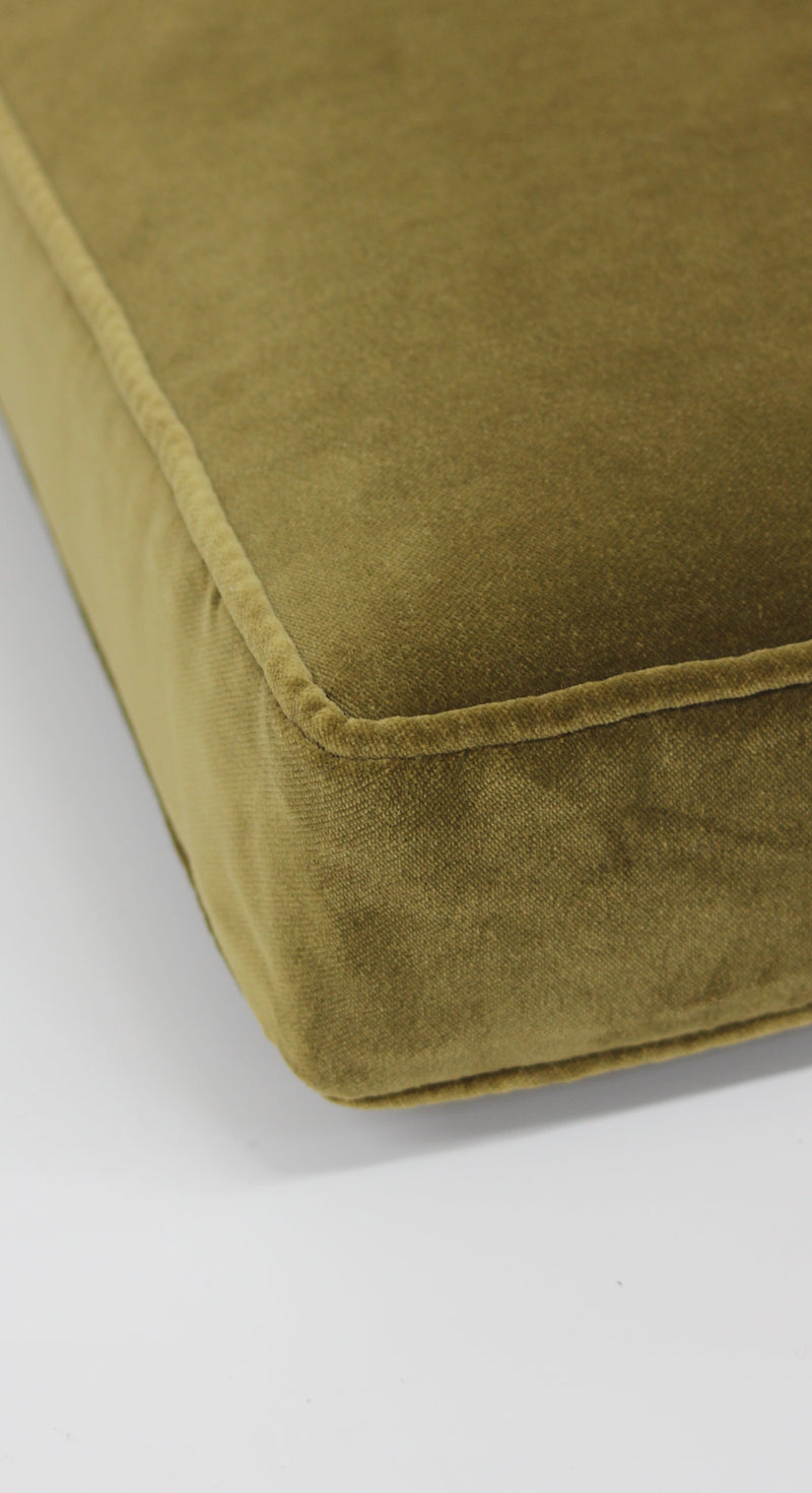Close-up of a green custom made cushion on a white background