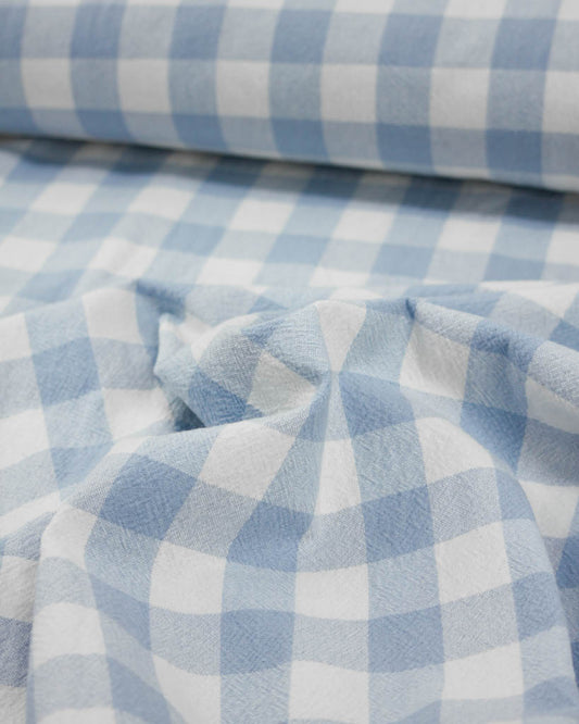 Close-up of blue and white checkered gingham cotton fabric