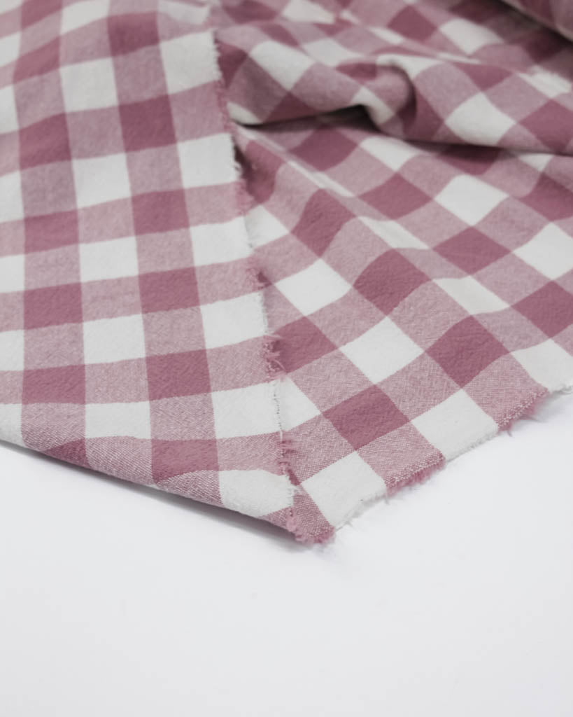Close-up of a pink and white checkered fabric on a white background