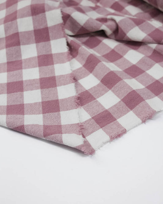 Close-up of a pink and white checkered fabric on a white background