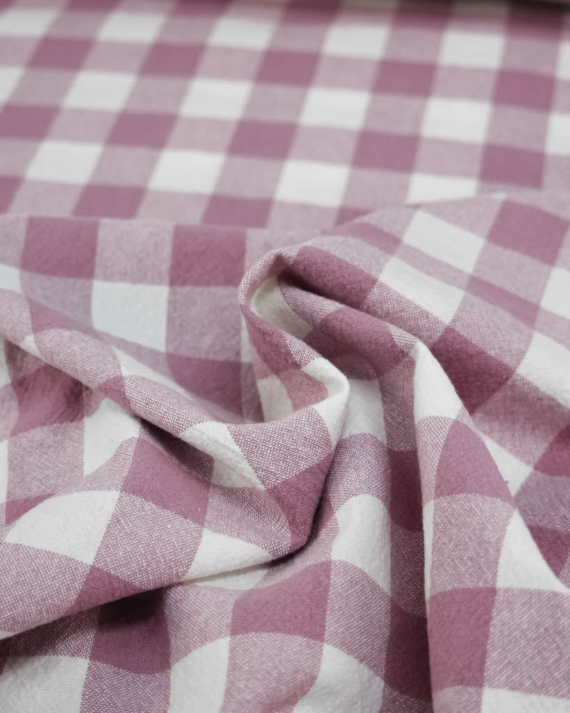 Close-up of pink and white checkered gingham organic cotton fabric