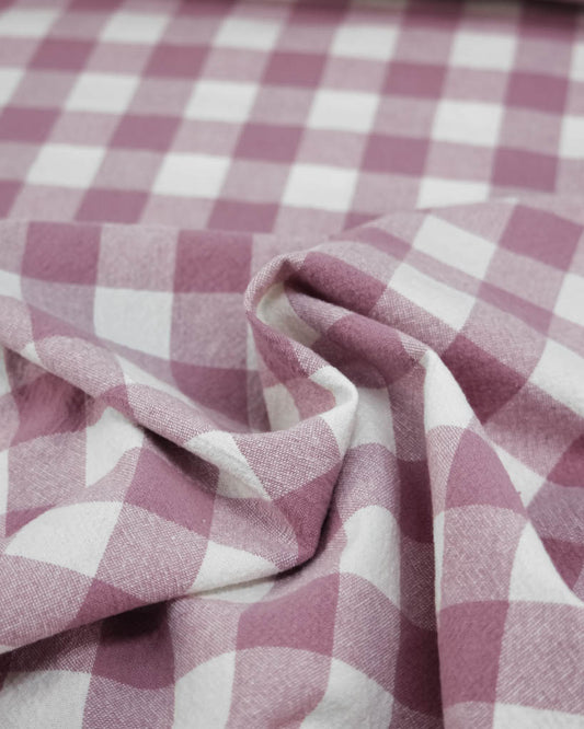 Close-up of pink and white checkered gingham organic cotton fabric