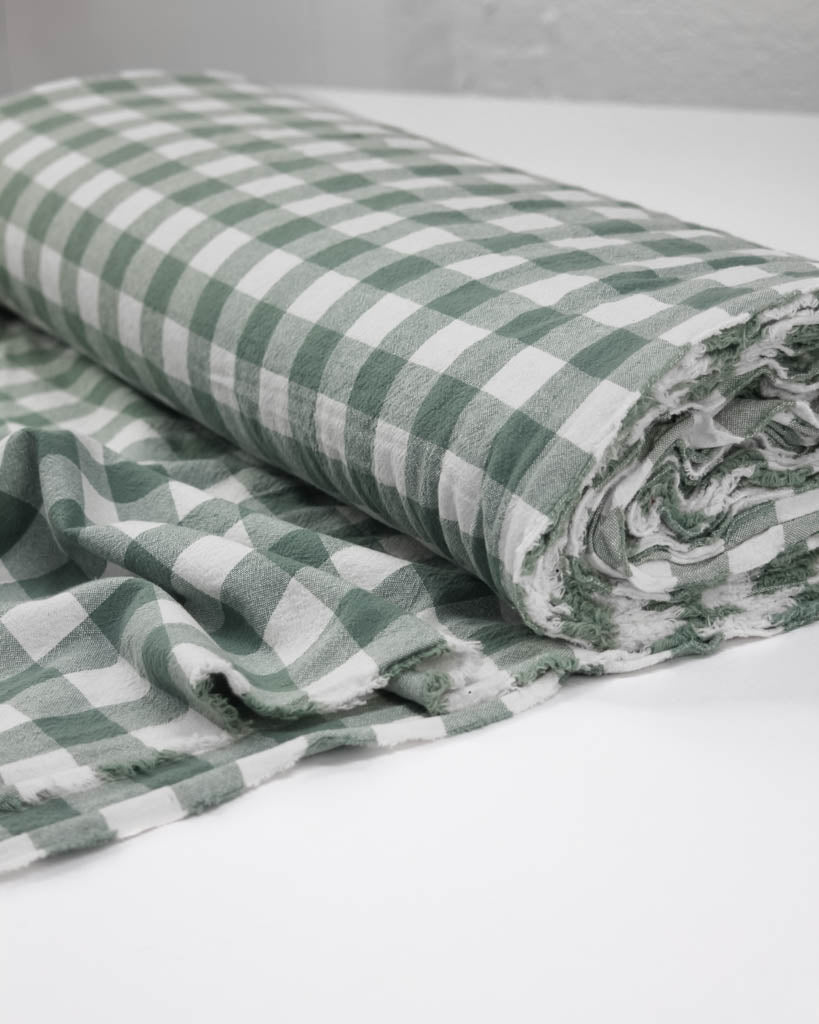 Green and white checkered fabric on a white background