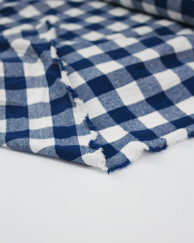 Close-up of blue and white checkered fabric on a white background