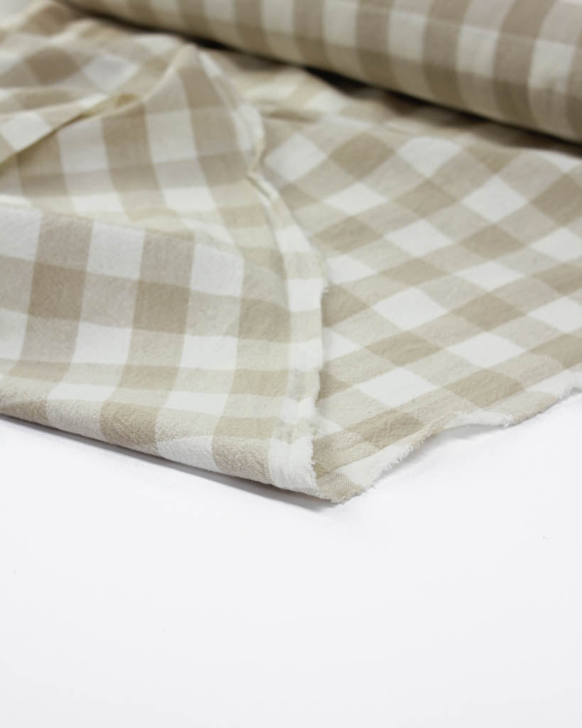 Beige and white checkered fabric on a white background