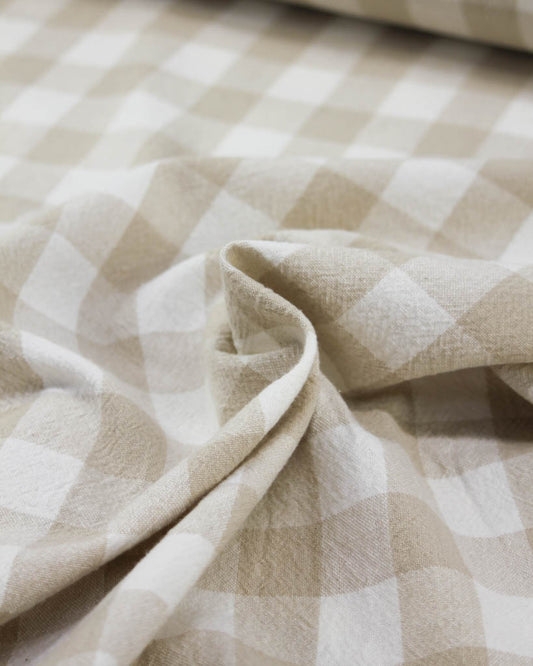 Close-up of beige and white checkered gingham cotton fabric