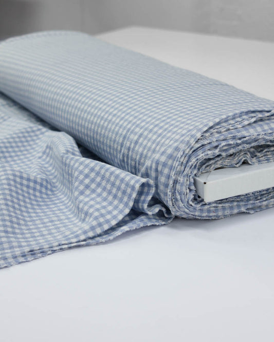 Roll of baby blue and white checkered gingham organic cotton fabric