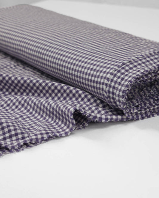 Folded checkered gingham organic cotton fabric in purple and white