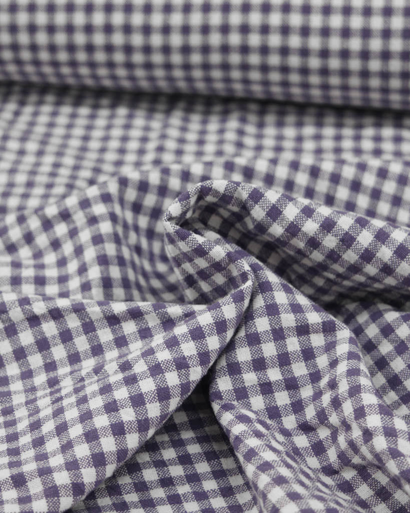 Close-up of purple and white checkered gingham organic cotton fabric