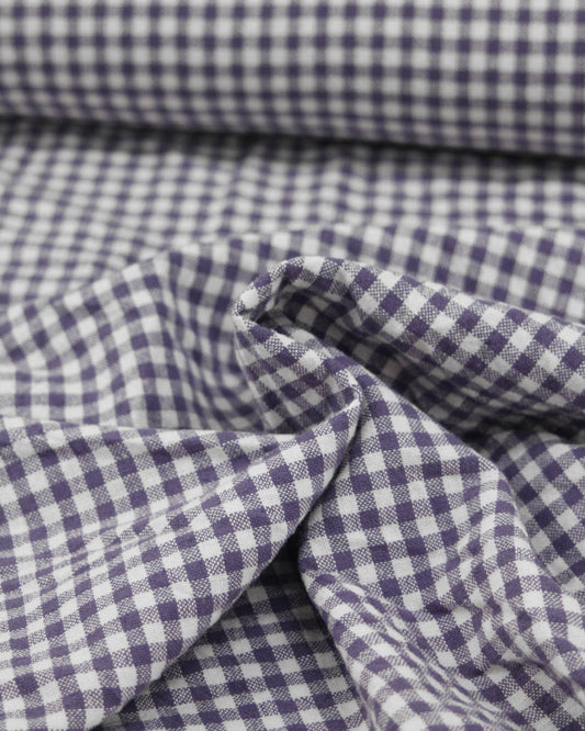Close-up of purple and white checkered gingham organic cotton fabric