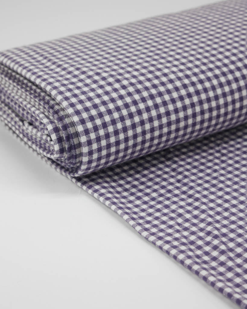 Bolt of of purple and white checkered gingham organic cotton fabric