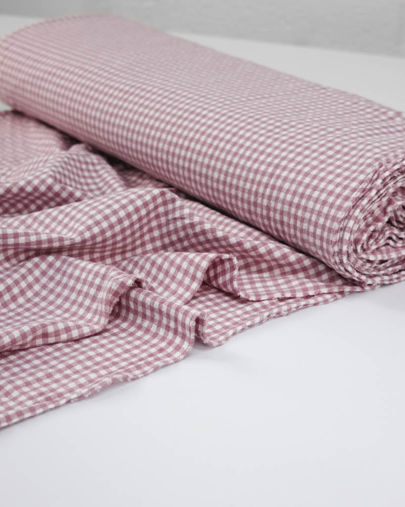 Roll of pink and white checkered gingham organic cotton fabric