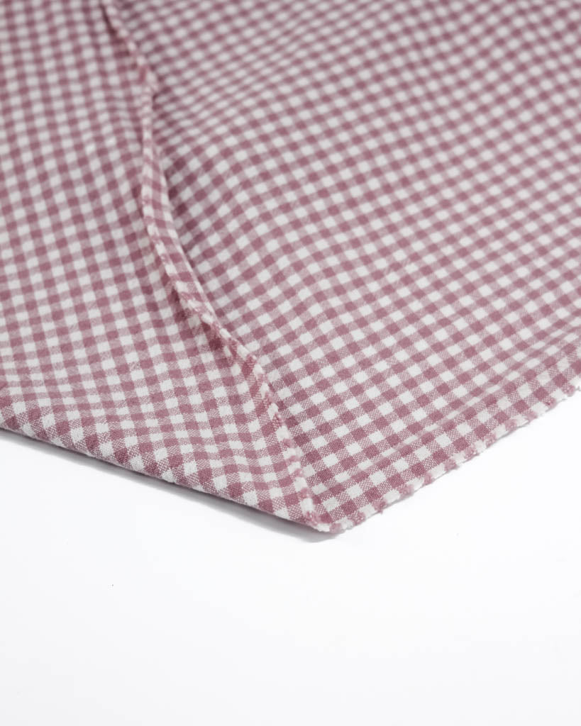 Close-up of pink and white checkered gingham organic cotton fabric