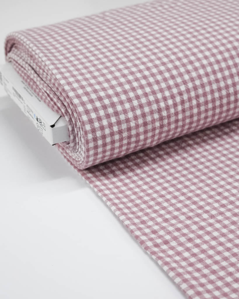 Roll of pink and white checkered gingham organic cotton fabric