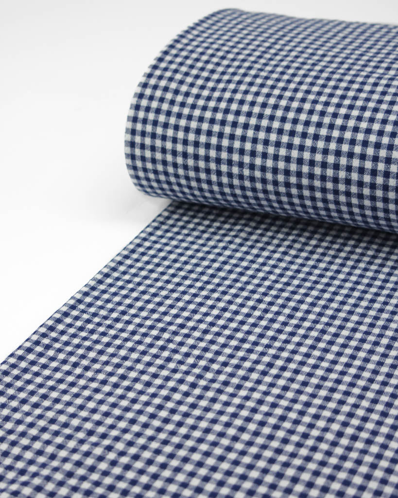 Roll of royal blue and white organic cotton gingham fabric