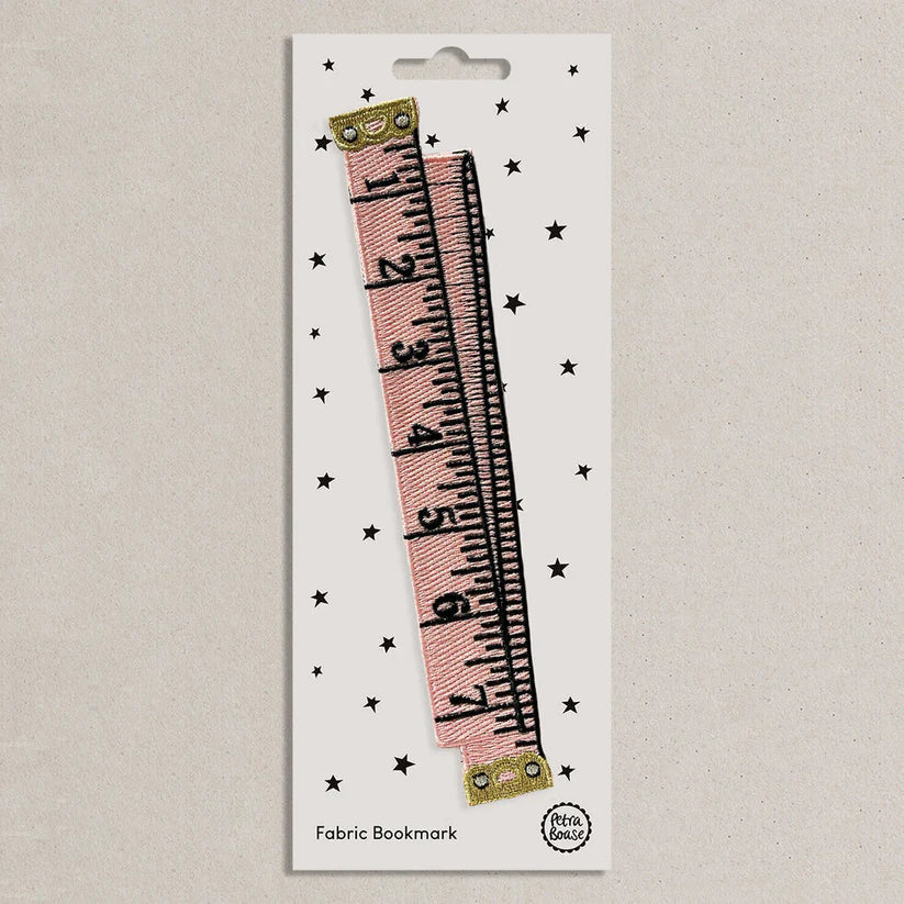 Fabric bookmark with pink tape measure design on a white card with star patterns