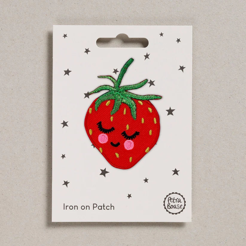Petra Boase strawberry iron-on embroidered patch featuring a bright red strawberry with green leaves on presentation card.
