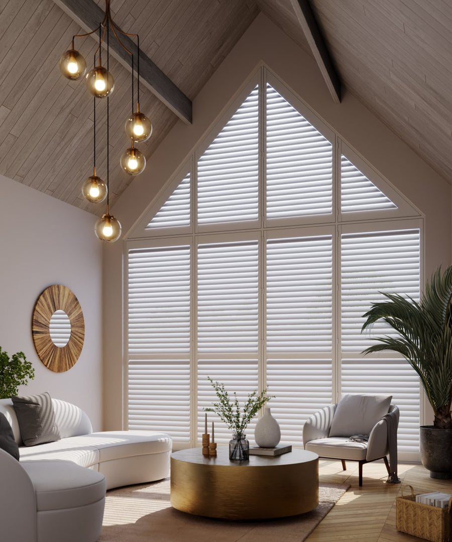 White bespoke shutters fitted to a tall apex window