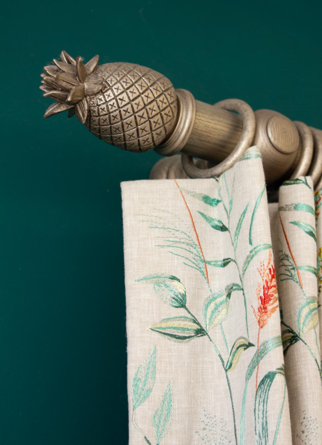 Pineapple curtain pole finial with patterned curtains