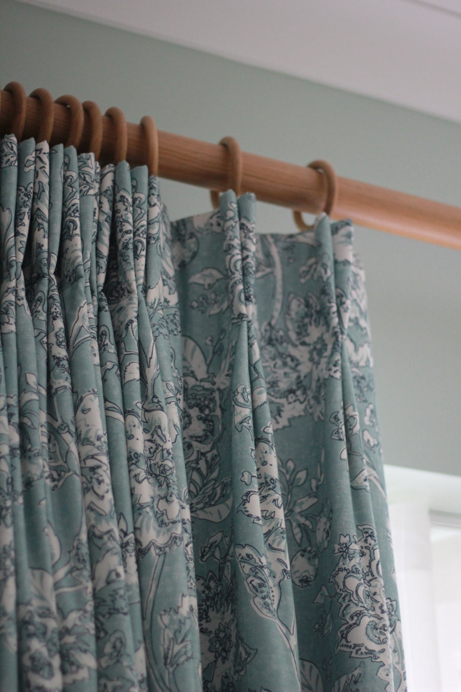Patterned made-to-measure curtains on a wooden pole