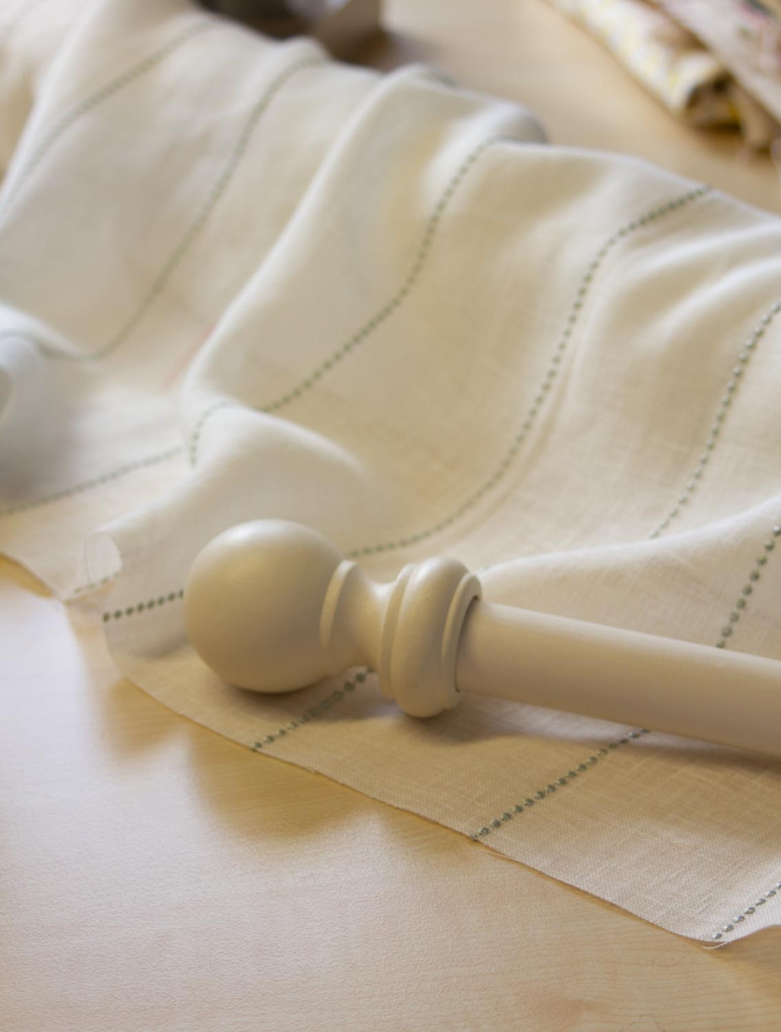 Matching curtain pole and softly striped fabric